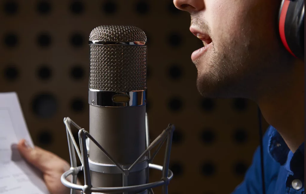 white male voice-over artist with microphone