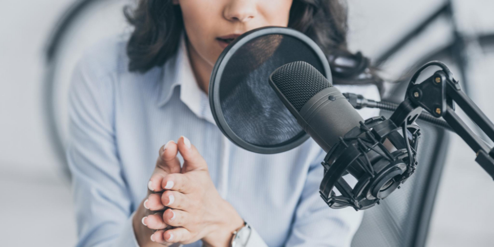 black female voice-over artist speaking into a microphone
